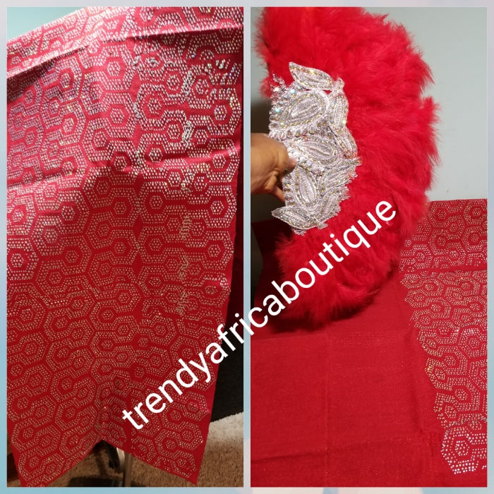Reduced price: Red million stoned Aso-oke set. 4pc wide Gele with 72" long Ipele (shoulder shawl). Sold as a set. Price is for set. Nigerian Celebrant Aso-oke set + fila piece from Nigeria. All over Swarovski stone work on gele/ipele. Colmes with fila