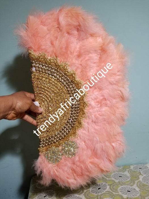 Peach  Feather hand fan. Medium size moon shape hand fan Nigerian  Bridal-accessories front and back  design with gold beads and flower petal. Limited quantity. 19" long + 14" wide. Small handle to hold your fan. Very class