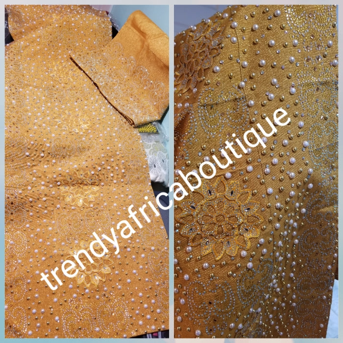 Latest Celebrant Gold Beaddazzled Aso-oke set. Extra 4 wide Gele with 76" long Ipele (shoulder shawl). Sold as a set. Price is for set. Nigerian Celebrant Aso-oke from Nigeria. Embellished luxury embriodery works, + beaded stone. Exclusive design