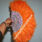 New arrival Orange Feather hand fan. Medium size moon shape hand fan Nigerian  Bridal-accessories front and back  design with gold beads and flower petal. Limited quantity. 19" long + 14" wide. Small handle to hold your fan. Very classy