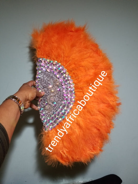 New arrival Orange Feather hand fan. Medium size moon shape hand fan Nigerian  Bridal-accessories front and back  design with gold beads and flower petal. Limited quantity. 19" long + 14" wide. Small handle to hold your fan. Very classy