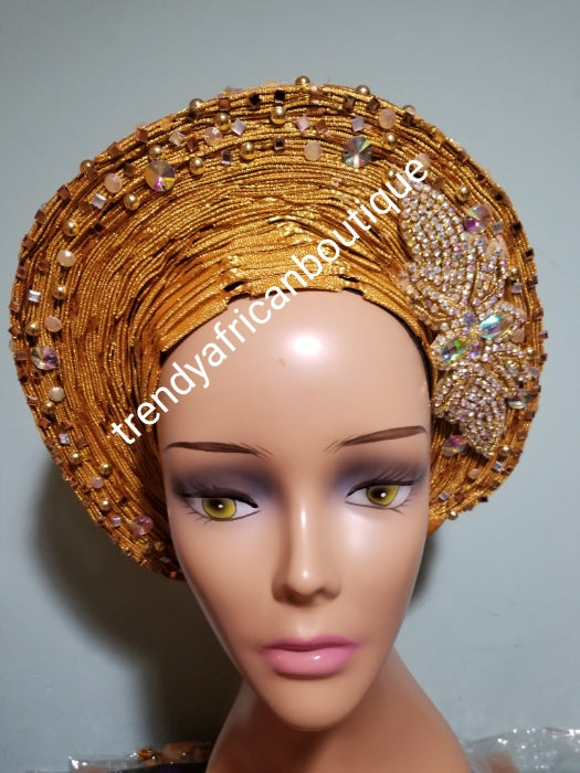 Beaded and stoned Gold Auto-gele made with quality Aso-oke. Beaded and stoned work front and back to perfection.  One size fit, easy to adjust  and knot at the back to secure your gele. This is true original auto gele