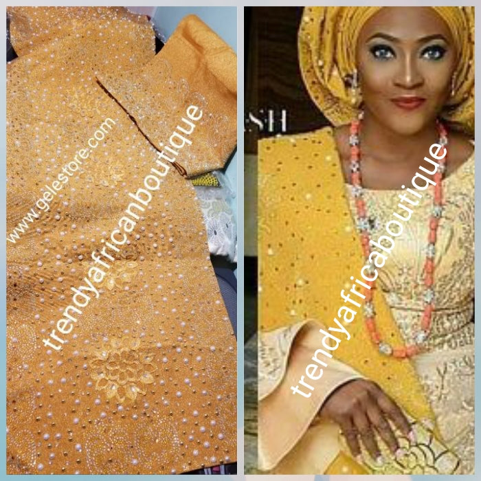 Latest Celebrant Gold Beaddazzled Aso-oke set. Extra 4 wide Gele with 76" long Ipele (shoulder shawl). Sold as a set. Price is for set. Nigerian Celebrant Aso-oke from Nigeria. Embellished luxury embriodery works, + beaded stone. Exclusive design
