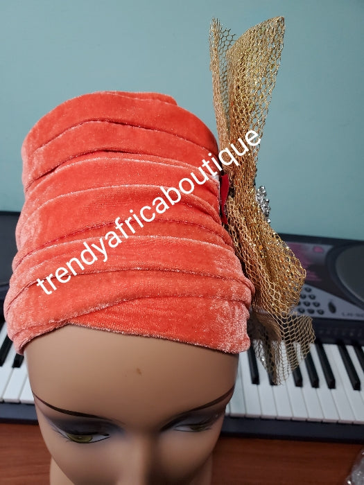 Orange velvet turban with gold color side design Women-turban. One size fit all turban. Beautiful flower design with a side brooch/beaded and stoned to add decor to your turban