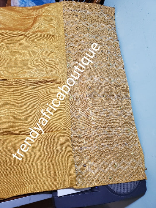 Beautiful Million stone Gold  aso-oke for making big gele for Nigeria traditional events. Hand woven and beaddazzled with crystal stones and beads at the border for perfect headwra. Gele only. Extra wide: 76" long × 26" wide