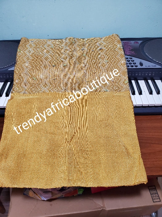 Beautiful Million stone Gold  aso-oke for making big gele for Nigeria traditional events. Hand woven and beaddazzled with crystal stones and beads at the border for perfect headwra. Gele only. Extra wide: 76" long × 26" wide