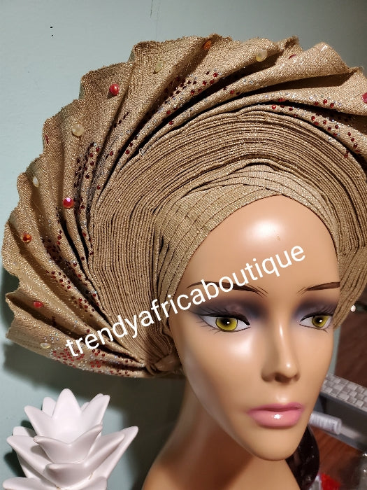 Quality champagne gold Auto-gele made with quality Aso-oke. Beaded and stoned work front and back to perfection.  One size fit, easy to adjust for fit and knot at the back to secure your gele. This is true original auto gele