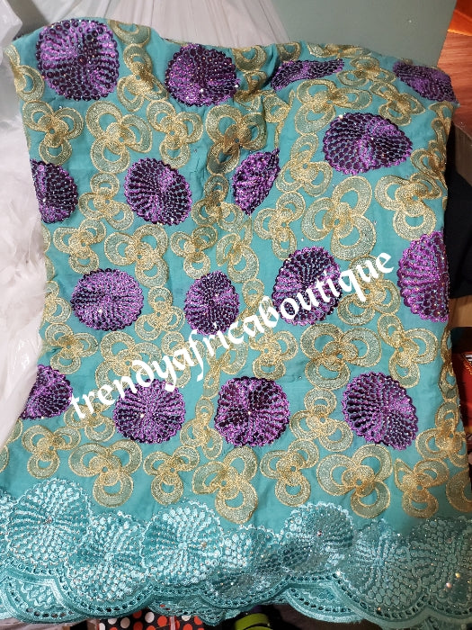 Exclusive swiss lace fabric mintgreen/purple/gold. Nigerian traditional celebrant Swiss lace embroidered with quality tread and all over crystal dazzling stones beautiful design. Sold per 5yds